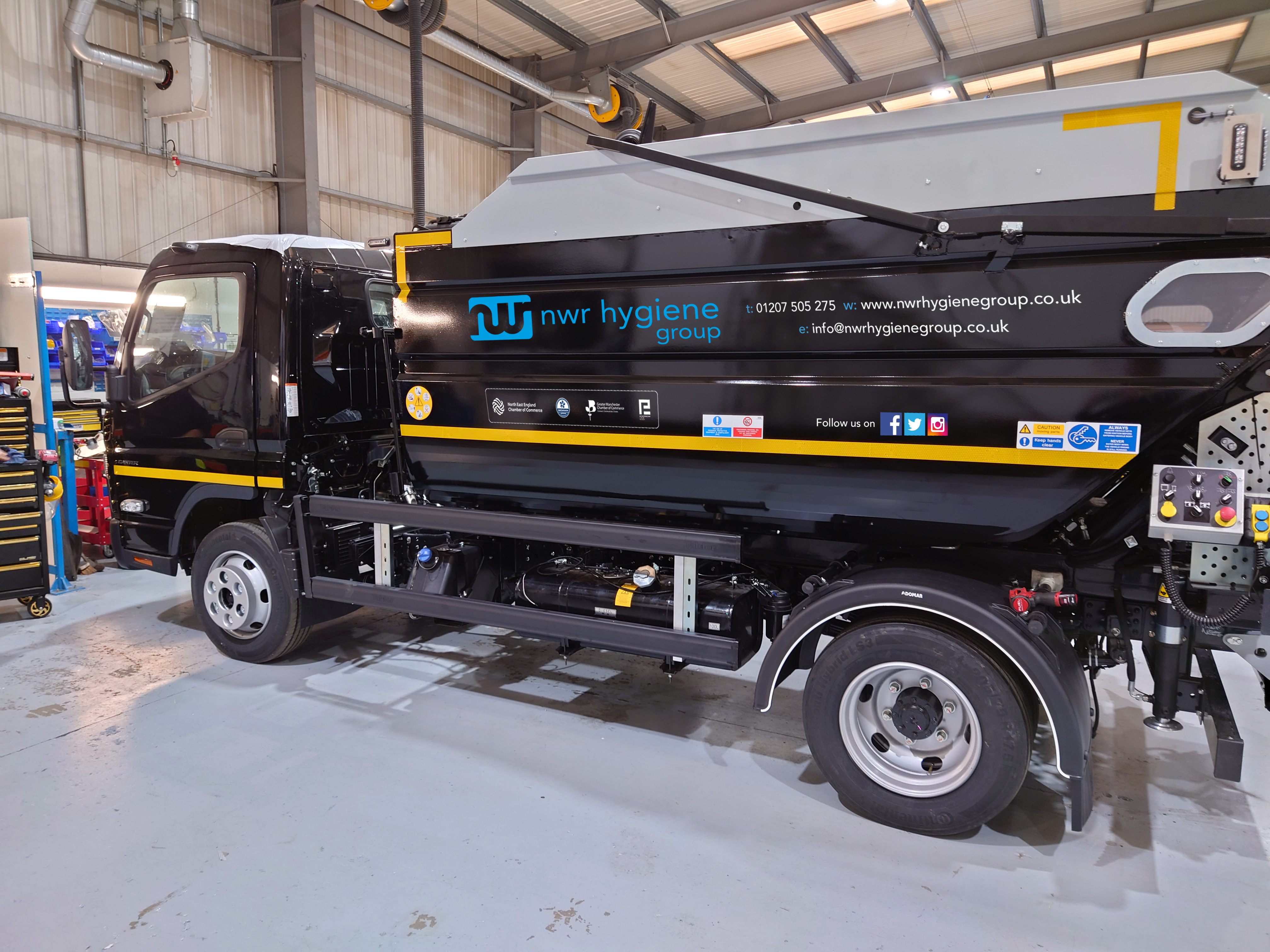NWR Hygiene truck parked in warehouse, side view