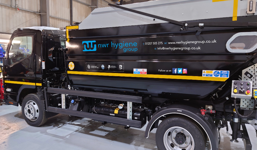 NWR Hygiene truck parked in warehouse, side view