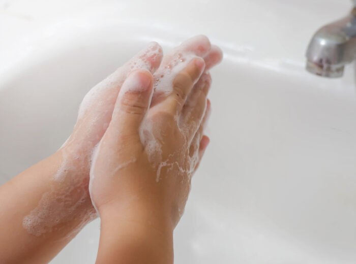 child washing hands with luxury foam soap