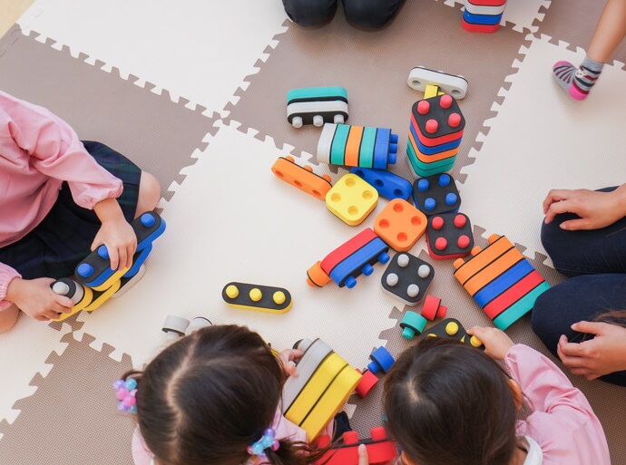 Children on the floor in a nursery facility