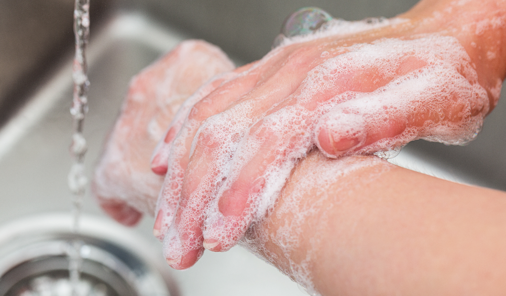 Male washing his hands with soap foam