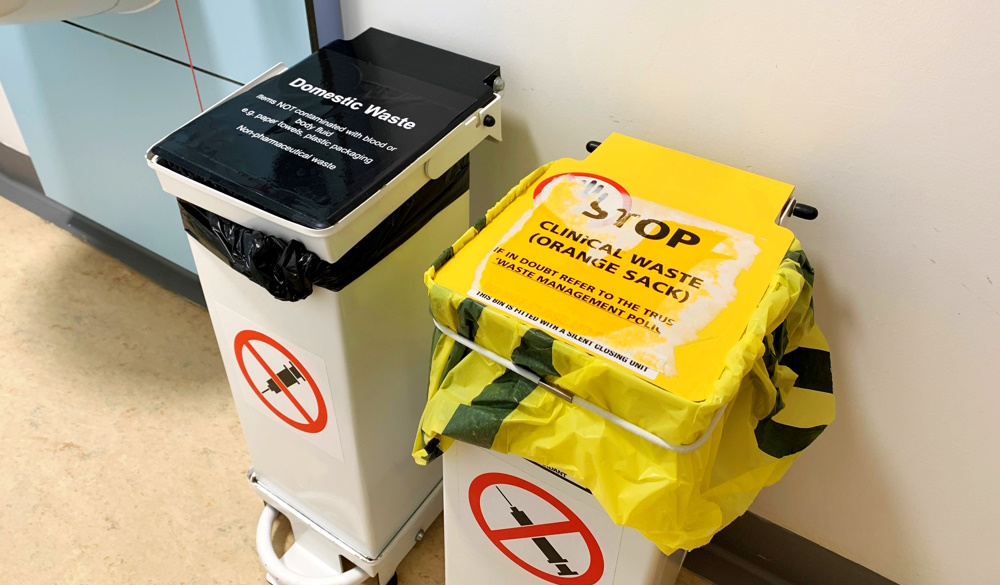 Domestic bin and clinical waste bins in a healthcare setting.