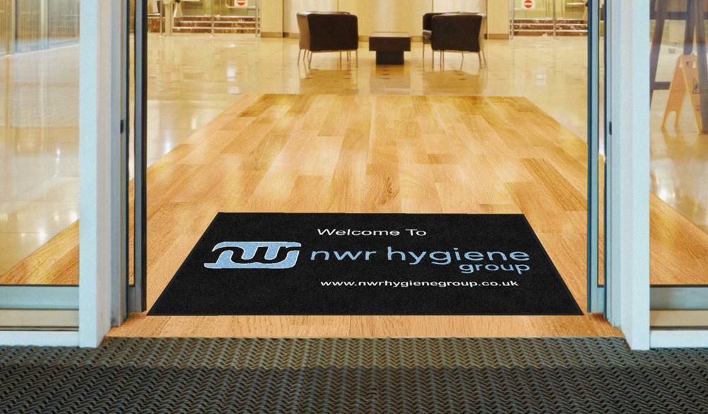 NWR-branded commercial entrance mats in the doorway to a commercial business. 