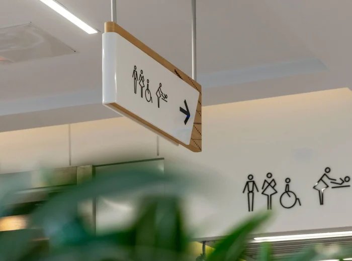 Public signage pointing to toilet facilities.