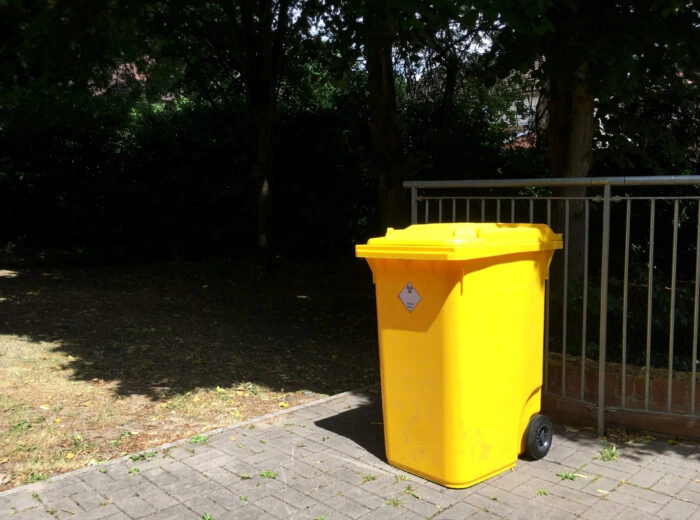 Yellow outdoor nappy waste bin.