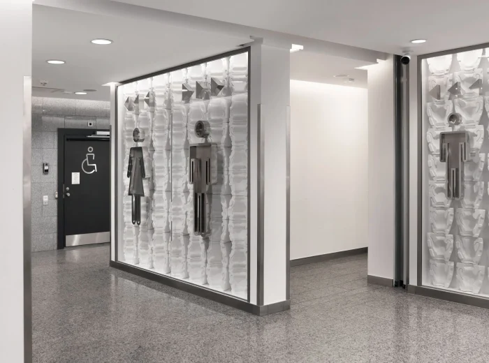 Outside multiple public bathrooms with disabled, female, and male signage.