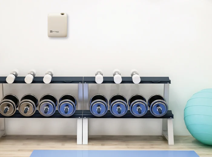 White wall-mounted ScentVision SV100 in a gym.