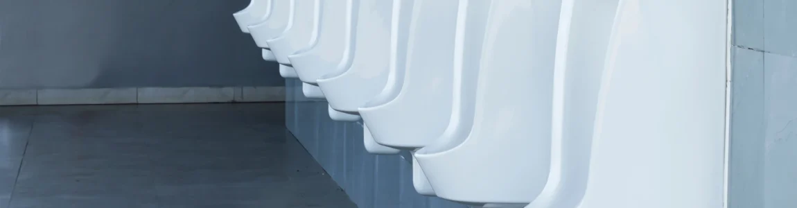 Row of urinals in clean modern washroom facilities.