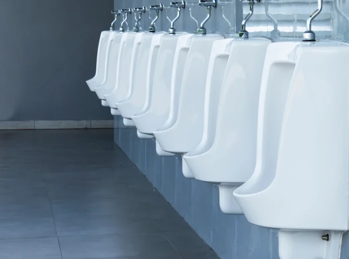 Row of urinals in clean modern washroom facilities.
