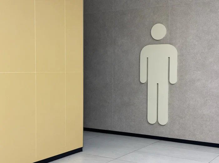 Large male washroom figure sign on wall.